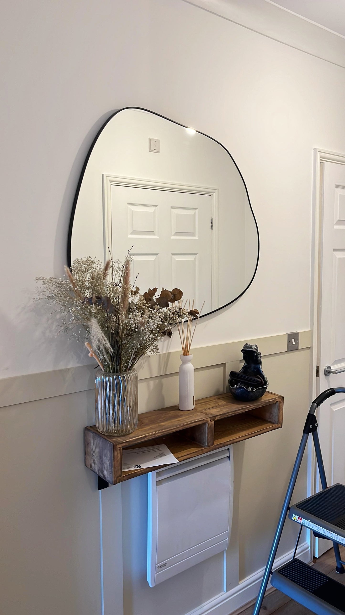 Ornica organic curved wall mirror 30 by 30 inches with matte black strapping for modern interiors