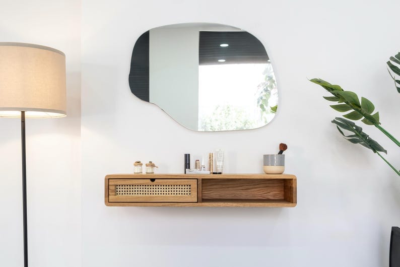 Whimsy Wall Vanity with Wooden Shelf and Irregular Mirror
Modern Minimalist Floating Vanity Table with Drawer
Compact Wall-Mounted Vanity for Bedroom or Office
Serene Vanity Setup with Lamp and Green Plant Accent