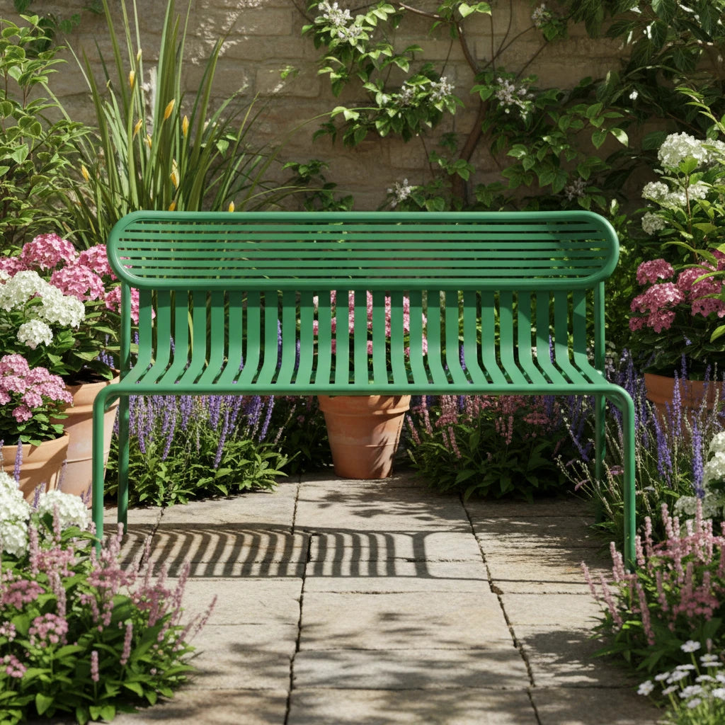 A green metal slatted bench with a rounded rectangular backrest and four legs, photographed against a clean white studio background.