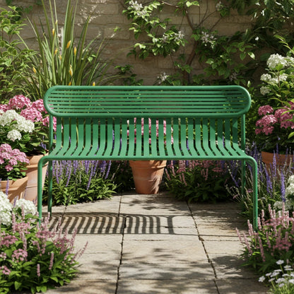 A green metal slatted bench with a rounded rectangular backrest and four legs, photographed against a clean white studio background.