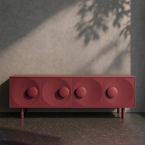 Red cabinet with circular design against a gray wall