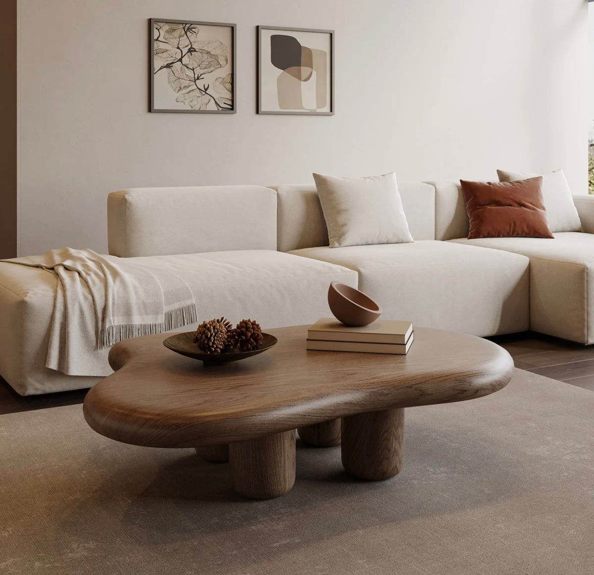 Modern wooden cloud-shaped coffee table with a smooth matte finish and rounded legs on a neutral rug. Overhead view of a minimalist  cloud-shaped coffee table featuring a smooth, organic curved edge and sturdy cylindrical wooden legs, placed in a bright living room