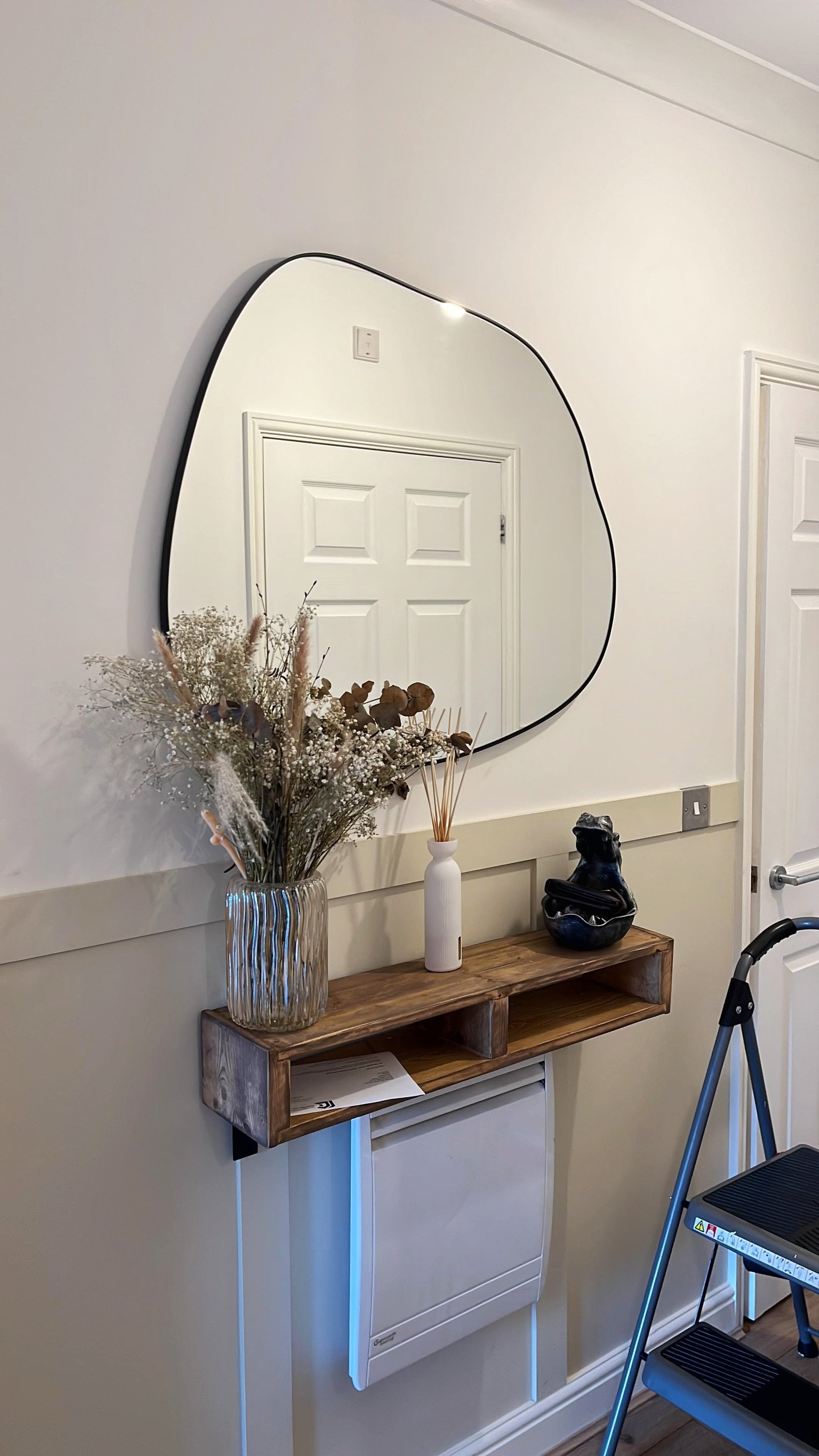 Ornica organic curved wall mirror 30 by 30 inches with matte black strapping for modern interiors