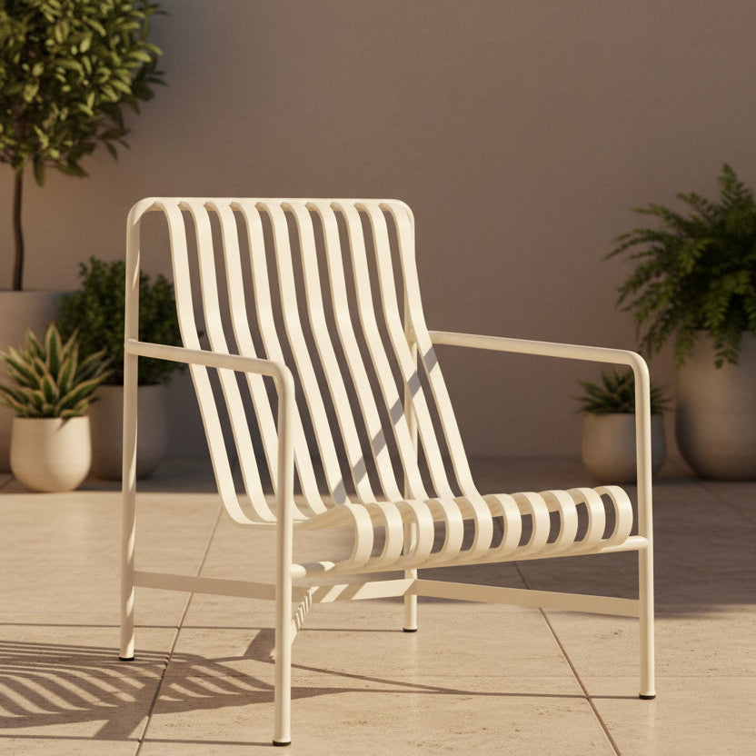 A modern white metal armchair with a slatted back and seat, shown from a three-quarter angle against a light gray studio background.