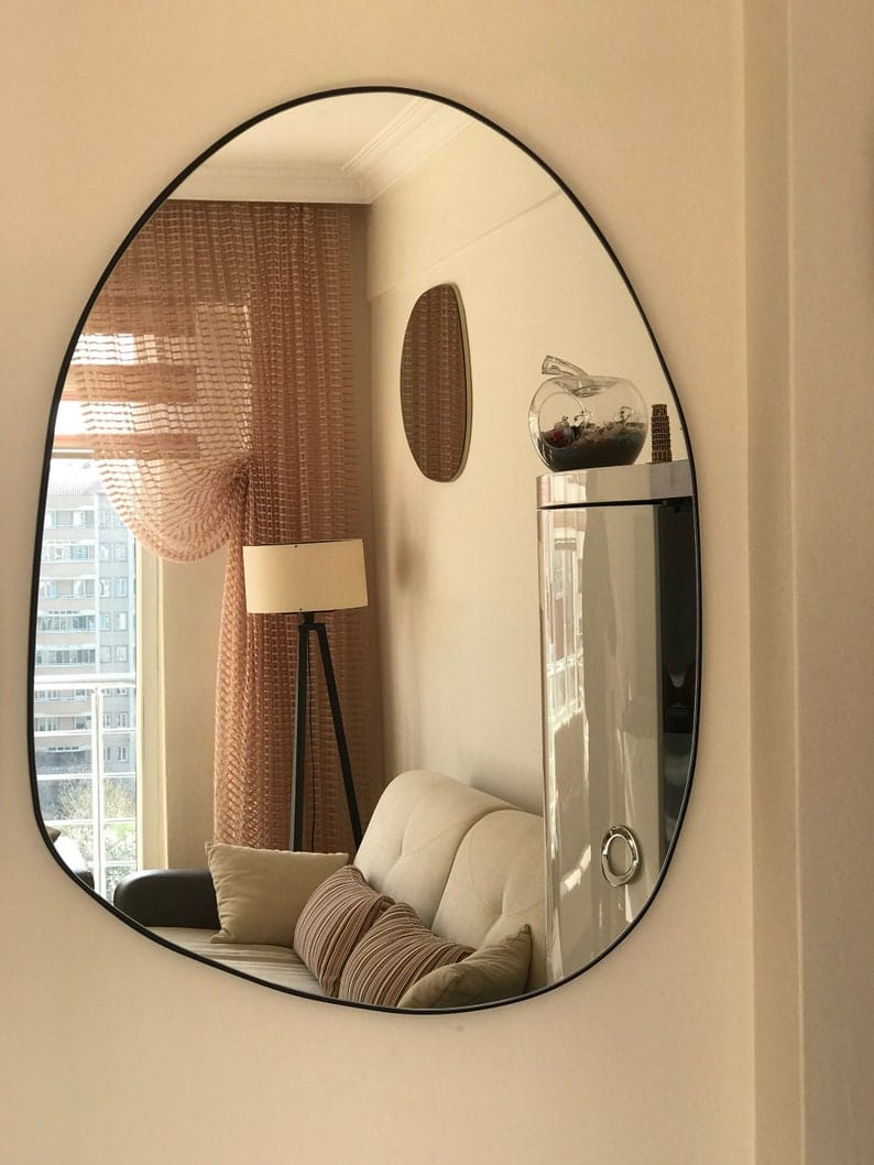 Modern asymmetrical Amorph Mirror with sleek frame, perfect for bathrooms, hallways, and living spaces.